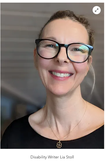 Lia Stoll, a light-skinned woman wearing seeing glasses and a black shirt.