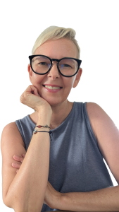 Disability Writer, Lia Stoll, a light-skinned woman with short blond hair, is wearing dark-framed glasses, a blue t-shirt.