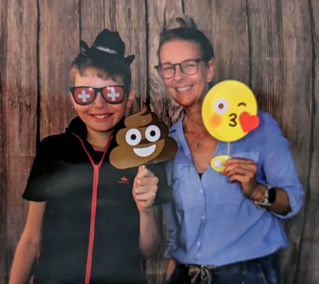 Lia Stoll and her son are posing with emojis.