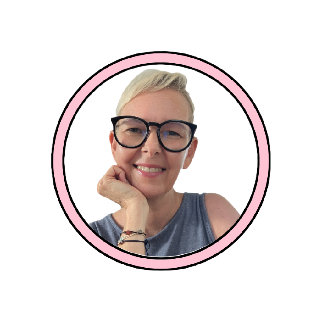 Disability Writer, Lia Stoll, a light-skinned woman with short blond hair, is wearing dark-framed glasses, a blue t-shirt.
